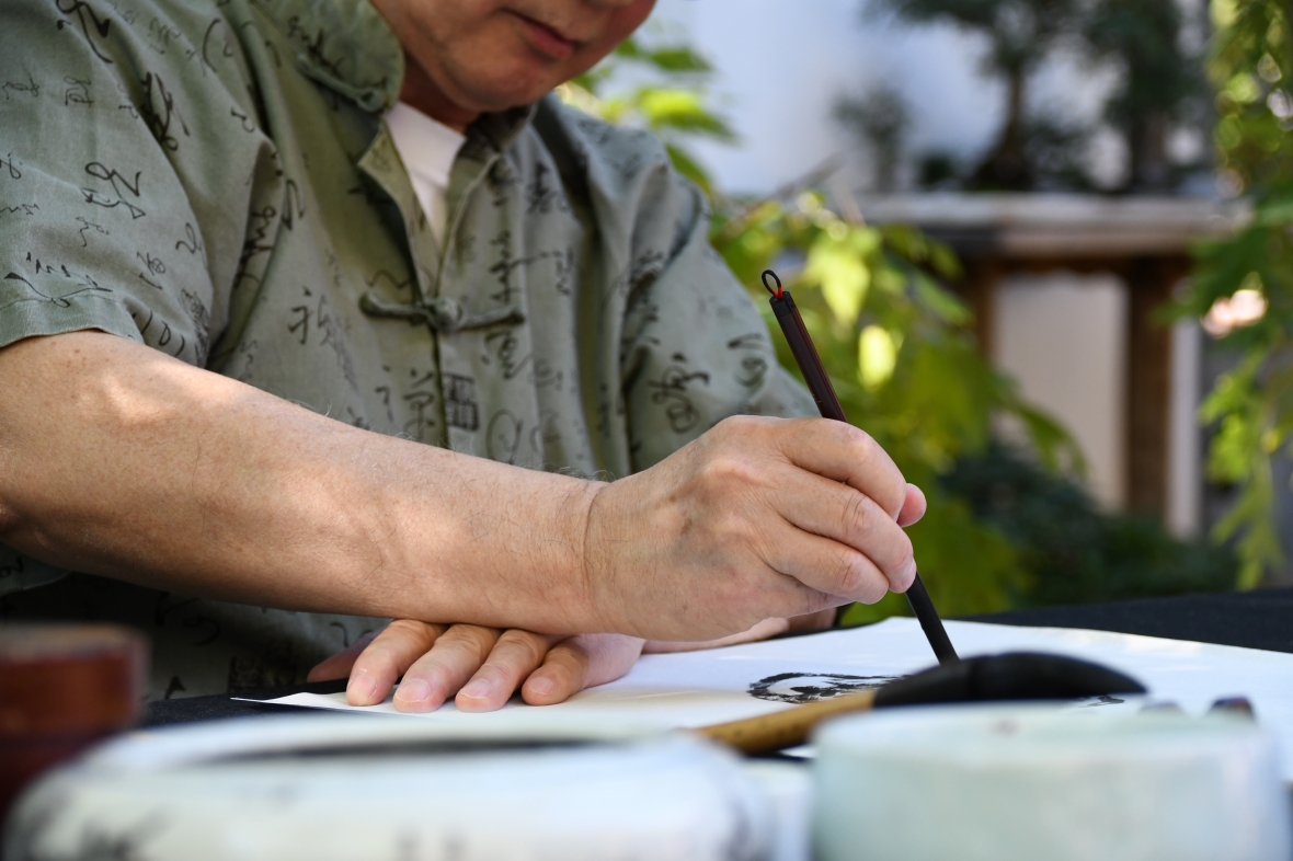 person doing calligraphy